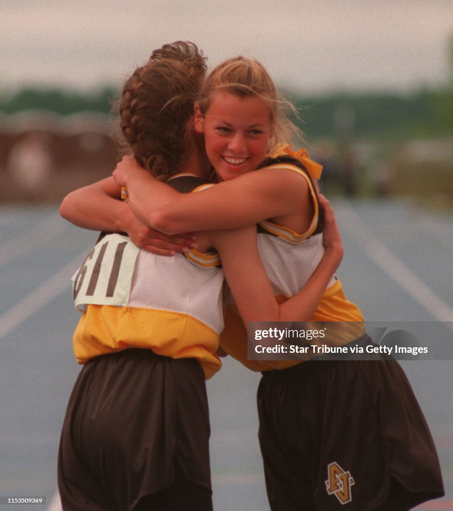 (Left to right) Apple Valley runners Jessie Lefebvre and Molly Hackett hug after winning the Class AA Girls 4X100 Meter Relay at the State Boys and Girls Track and Field Meet in Blaine