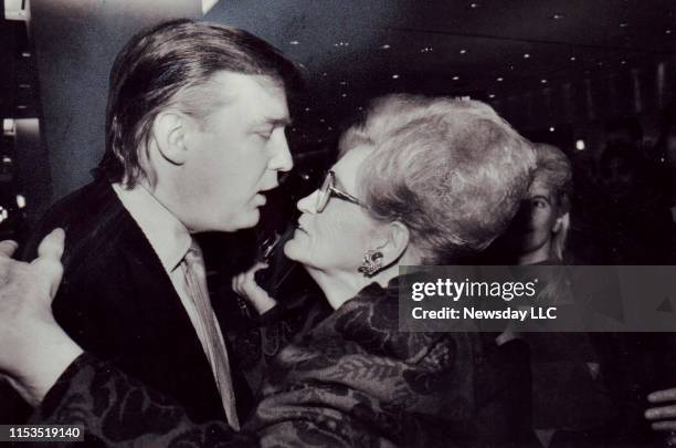 Real estate executive Donald Trump embraces his mother Mary Trump at the opening of the first Galleries Lafayette in the United States at Trump Tower...