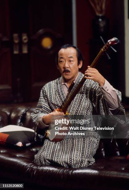 Pat Morita, wearing traditional Japanese kimono playing shamisen, appearing in the ABC tv series 'Mr T and Tina'.