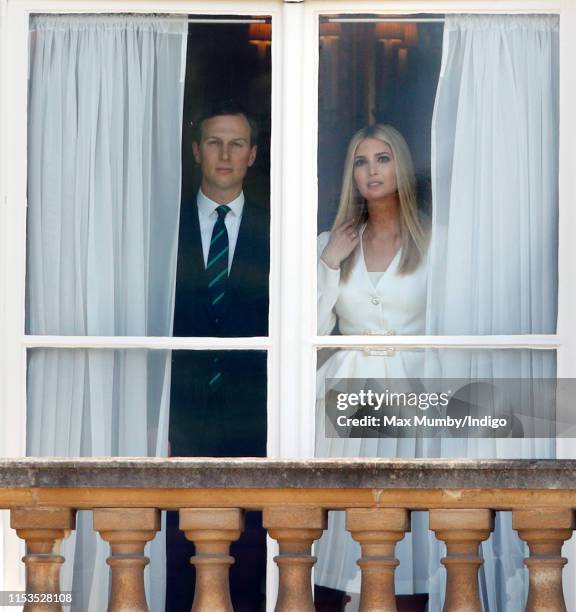 Jared Kushner and Ivanka Trump look out of a window of Buckingham Palace during the Ceremonial Welcome in the Buckingham Palace Garden for US...