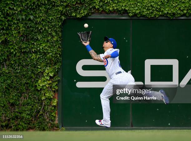 Carlos Gonzalez of the Chicago Cubs dives to make a catch in the seventh inning against the Los Angeles Angels at Wrigley Field on June 03, 2019 in...