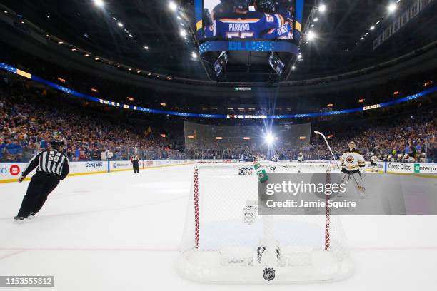 Brayden Schenn of the St. Louis Blues celebrates his empty-net goal in the third period at 18:31 as Tuukka Rask of the Boston Bruins looks on in Game...