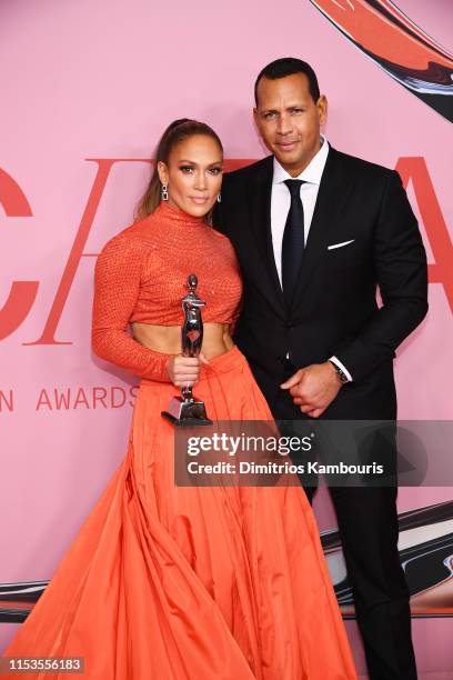Jennifer Lopez poses with the Fashion Icon Award and Alex Rodriguez during Winners Walk during the CFDA Fashion Awards at the Brooklyn Museum of Art...