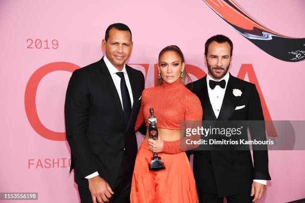 Jennifer Lopez poses with the Fashion Icon Award, Tom Ford and Alex Rodriguez during Winners Walk during the CFDA Fashion Awards at the Brooklyn...