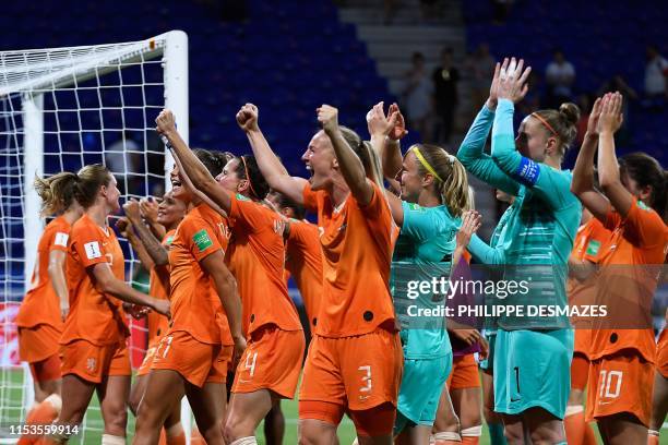 Netherlands players celebrate after winning the France 2019 Women's World Cup semi-final football match between the Netherlands and Sweden, on July 3...