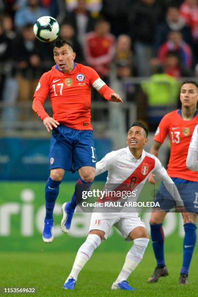 Peru's Christian Cueva and Chile's Gary Medel vie for the ball during their Copa America football tournament semi-final match at the Gremio Arena in...