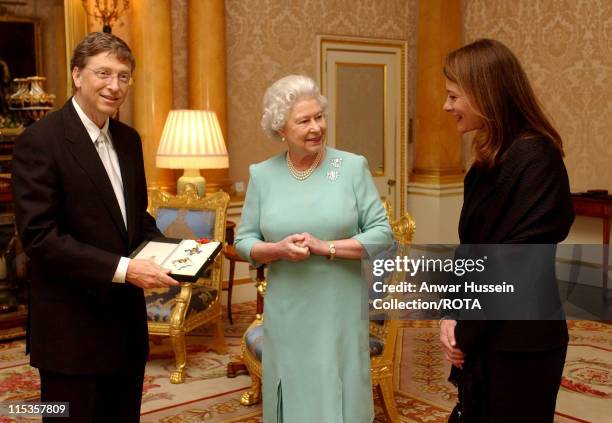 The Queen Elizabeth II presents Microsoft tycoon Bill Gates with his honorary knighthood at Buckingham Palace, London, Wednesday March 2, 2005...