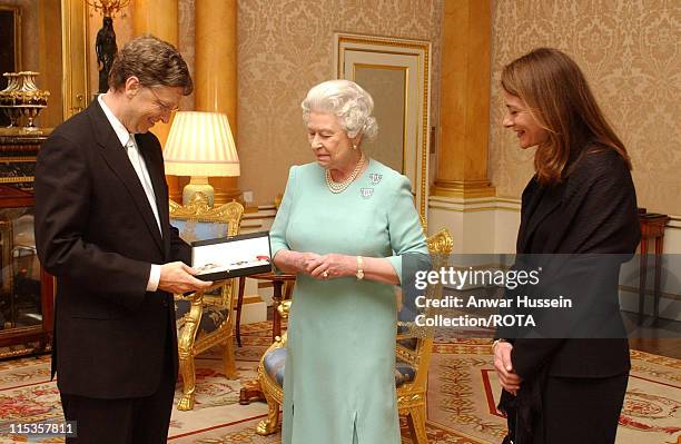 The Queen Elizabeth II presents Microsoft tycoon Bill Gates with his honorary knighthood at Buckingham Palace, London, Wednesday March 2, 2005...