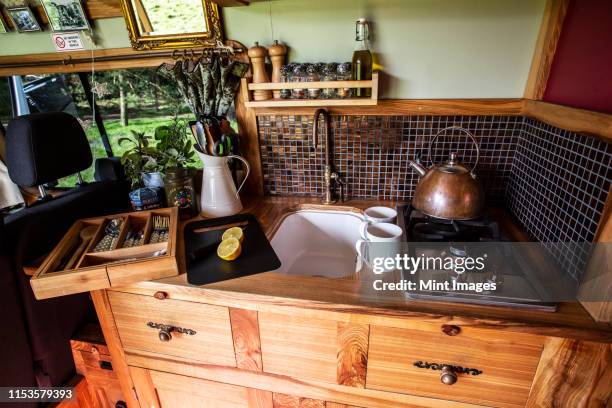 interior view of camper van with small cooking area and sink. - narrow kitchen stock pictures, royalty-free photos & images