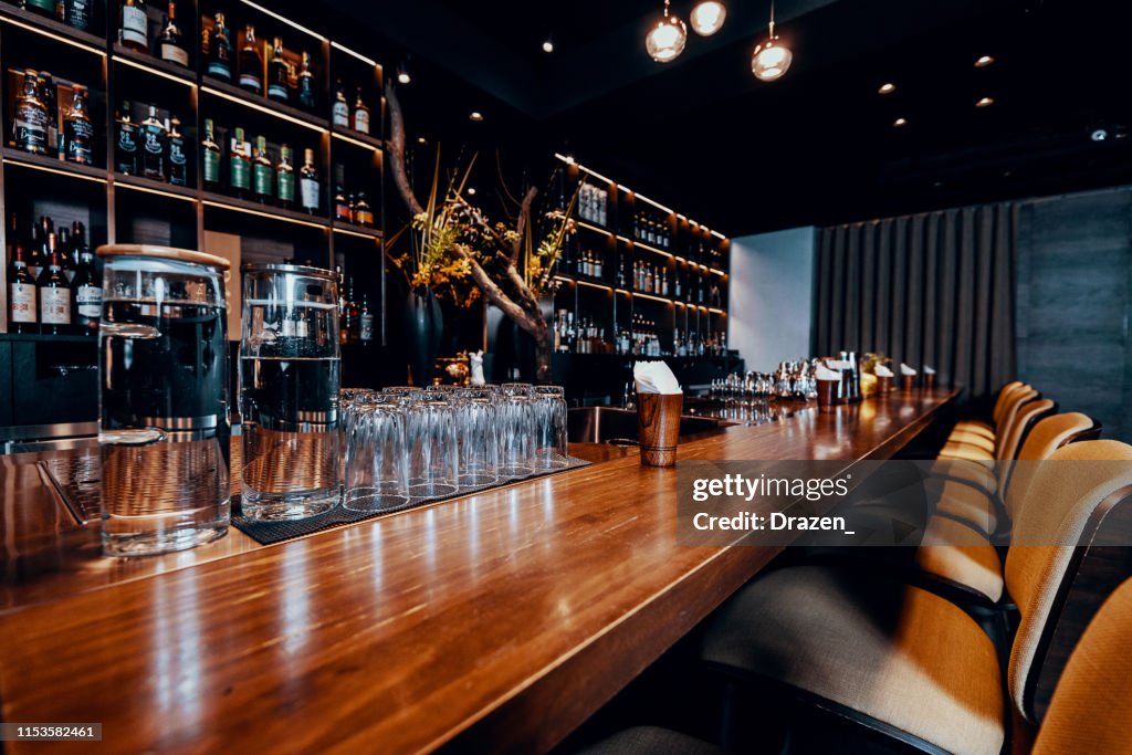 Modern empty night bar, wide angle near bar counter.