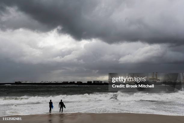 Two young bodyboarders contemplate paddling out as huge waves break inside Botany Bay on June 04, 2019 in Sydney, Australia. The Bureau of...