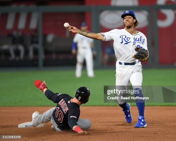 Adalberto Mondesi of the Kansas City Royals forces out Jake Bauers of the Cleveland Indians for the first half of a double play in the seventh inning...