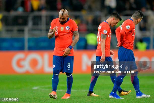 Chile's Arturo Vidal , Gary Medel and Charles Aranguiz return to the field for the second half of their Copa America football tournament semi-final...