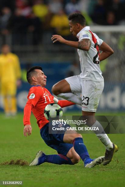Peru's Christofer Gonzales vies for the ball with Chile's Gary Medel during their Copa America football tournament semi-final match at the Gremio...