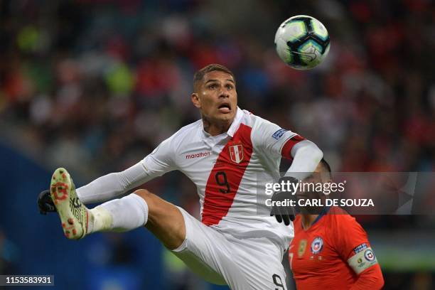 Peru's Paolo Guerrero controls the ball over Chile's Gary Medel during their Copa America football tournament semi-final match at the Gremio Arena in...