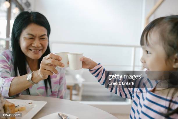 drinking water with family at the cafe - disposable cup stock pictures, royalty-free photos & images