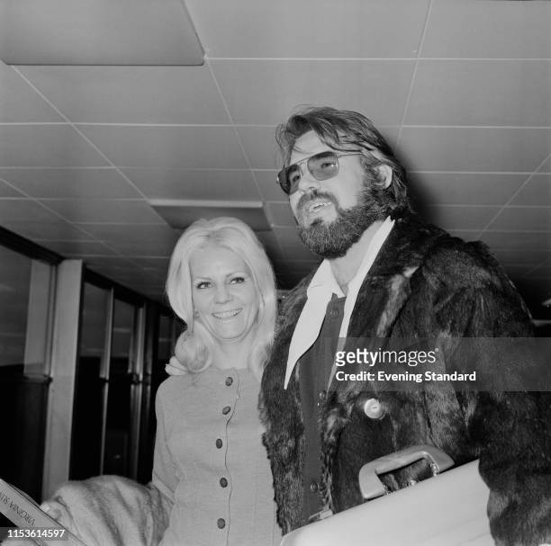 American singer, songwriter, actor, record producer, and entrepreneur Kenny Rogers with his wife Margo Anderson at Heathrow Airport, London, UK, 24th...