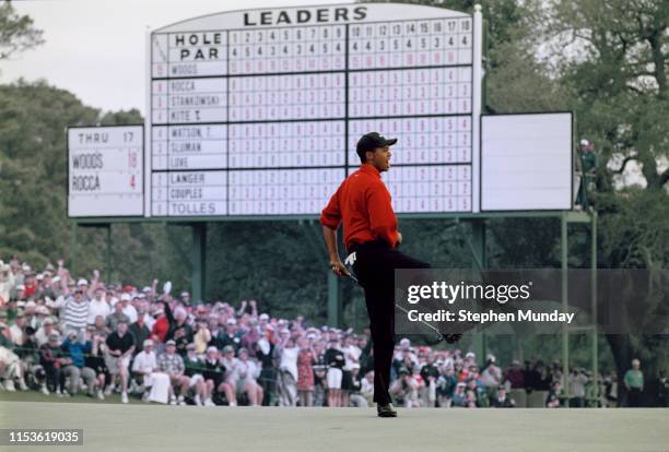 Tiger Woods of the United States celebrates after sinking a 4 feet putt to win the US Masters Golf Tournament with a record low score of 18 under par...