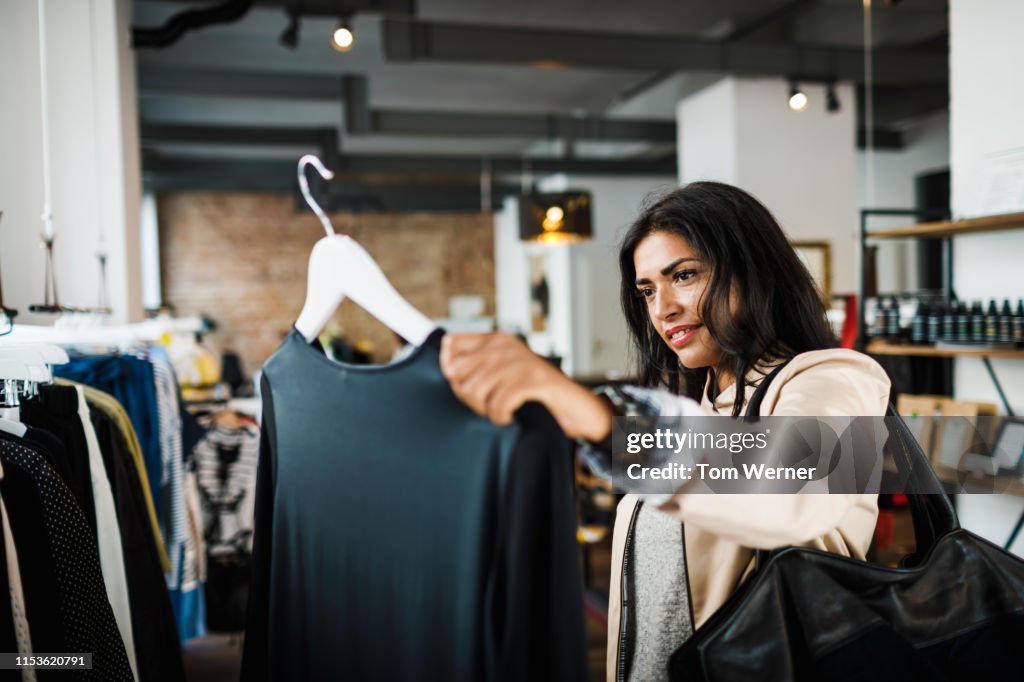 Woman Looking At Blouse While Out Shopping