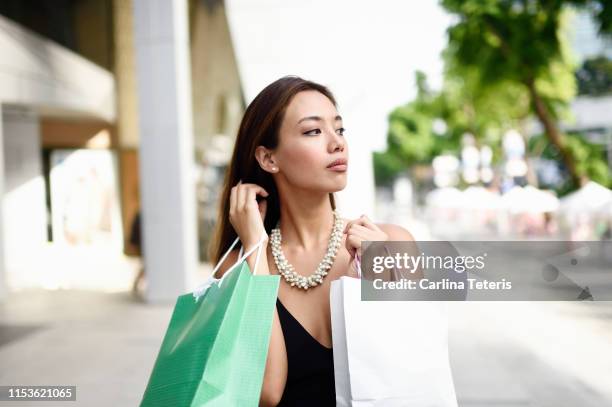 glamorous young woman shopping on orchard road - budding starlets stock pictures, royalty-free photos & images