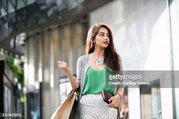 portrait of a wealthy indian woman outside a luxury mall - luxus shopping stock-fotos und bilder