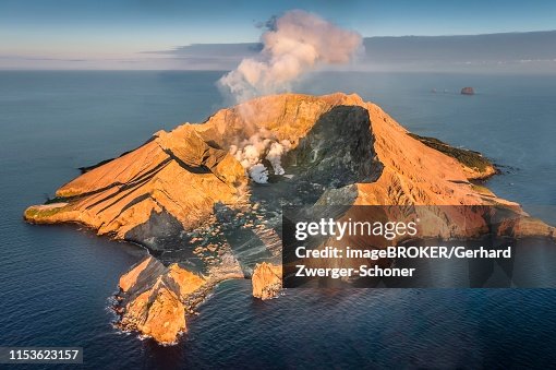 Aerial view of the volcanic island White Island with view into the crater, rising steam, morning mood, Whakaari, volcanic island, Bay of Plenty, North Island, New Zealand Aerial view of the volcanic island White Island with view into the crater, rising steam, morning mood, Whakaari, volcanic island, Bay of Plenty, North Island, New Zealand