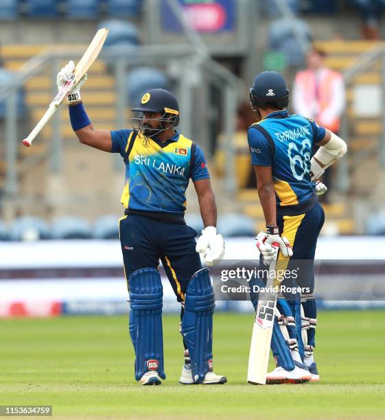 Kusal Janith Perera of Sri Lanka celebrates his half century with team mate Lahiru Thirimanna during the Group Stage match of the ICC Cricket World...