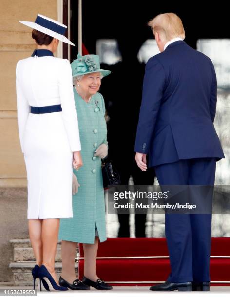 Queen Elizabeth II greets Melania Trump and U.S. President Donald Trump as they attend their Ceremonial Welcome in the Buckingham Palace Garden on...