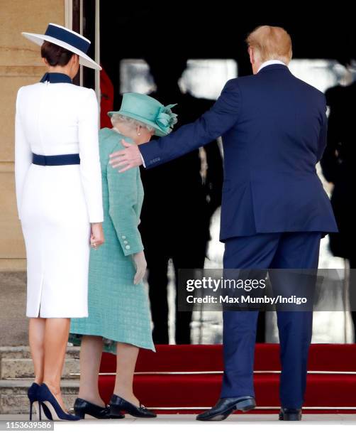 Queen Elizabeth II escorts Melania Trump and U.S. President Donald Trump into Buckingham Palace as they attend their Ceremonial Welcome in the...