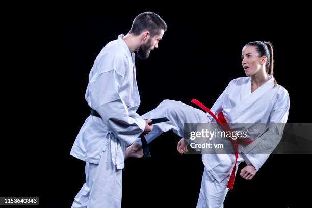 practicing karate kicks - karate stock pictures, royalty-free photos & images