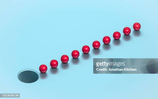 Red balls in line near hole