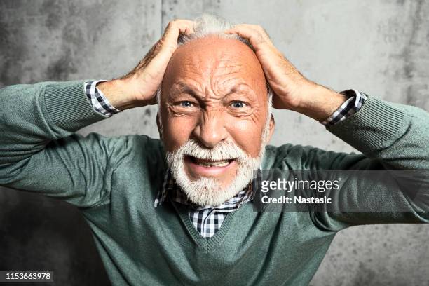 frustrated mature man - pulling hair stock pictures, royalty-free photos & images
