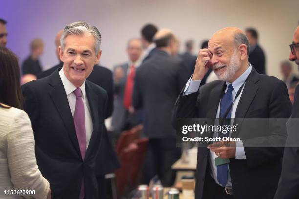 Jerome Powell , Chair, Board of Governors of the Federal Reserve and former chair Ben Bernanke speak to guests during a conference at the Federal...
