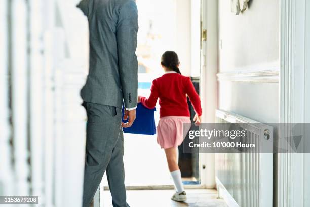 enthusiastic schoolgirl running through open doorway in morning - confidence family stock pictures, royalty-free photos & images