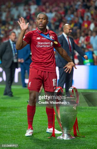 Daniel Sturridge of Liverpool performs his famous goal celebration dance with the trophy after winning the UEFA Champions League Final between...