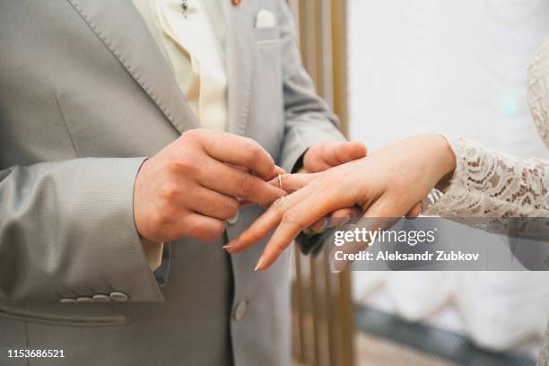 Exchanging Of Rings Couple Exchanging Rings Photos and Premium High Res Pictures - Getty Images