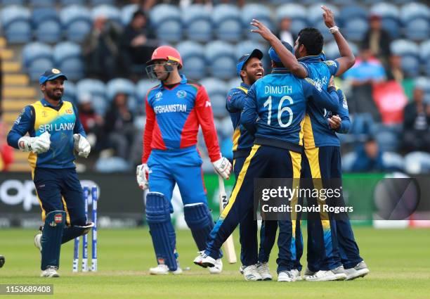 Thisara Perera of Sri Lanka celebrates with team mates after bowling Mohammad Nabi during the Group Stage match of the ICC Cricket World Cup 2019...