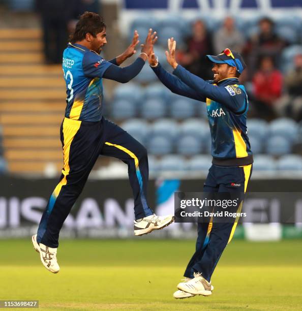 Nuwan Pradeep of Sri Lanka celebrates with team mate Dhananjaya Silva after bowling Rashid Khan during the Group Stage match of the ICC Cricket World...