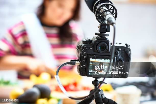 video camera filming woman preparing food - tutorial stockfoto's en -beelden