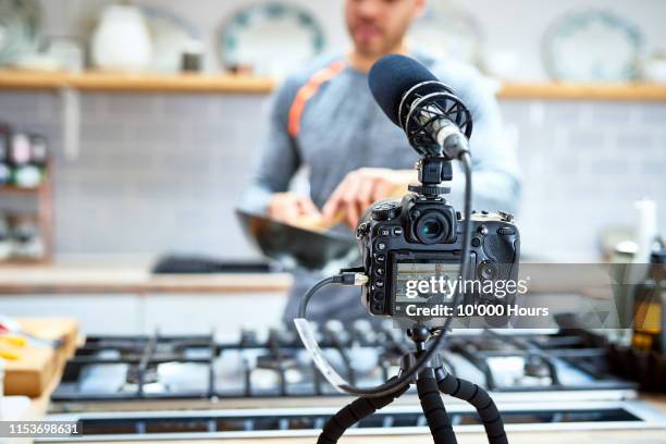 video camera set up to film man cooking in kitchen - gifted film ストックフォトと画像