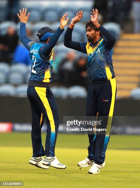 Nuwan Pradeep of Sri Lanka celebrates with team mate Kusal Mendis after bowling Rashid Khan during the Group Stage match of the ICC Cricket World Cup...