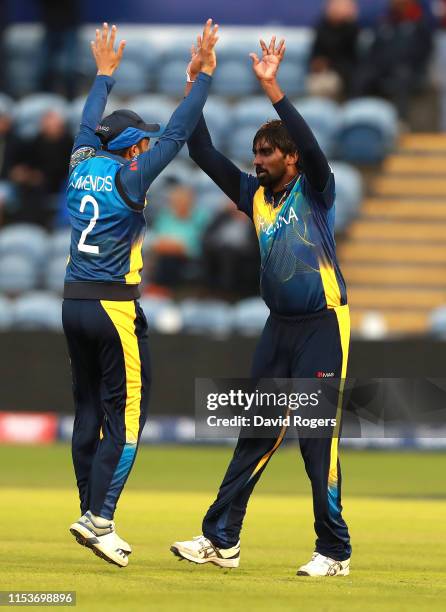 Nuwan Pradeep of Sri Lanka celebrates with team mate Kusal Mendis after bowling Rashid Khan during the Group Stage match of the ICC Cricket World Cup...