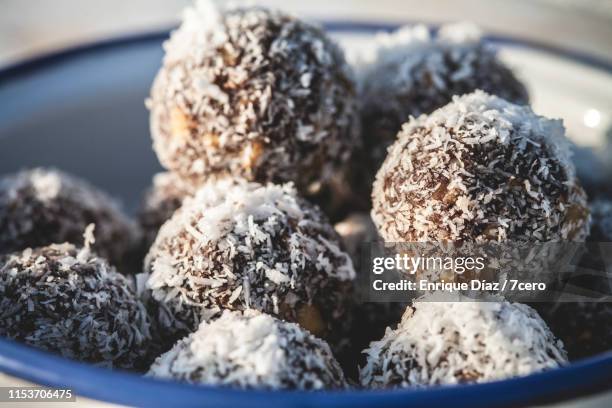 chocolate walnut energy balls in bowl - chocolate truffles stock pictures, royalty-free photos & images