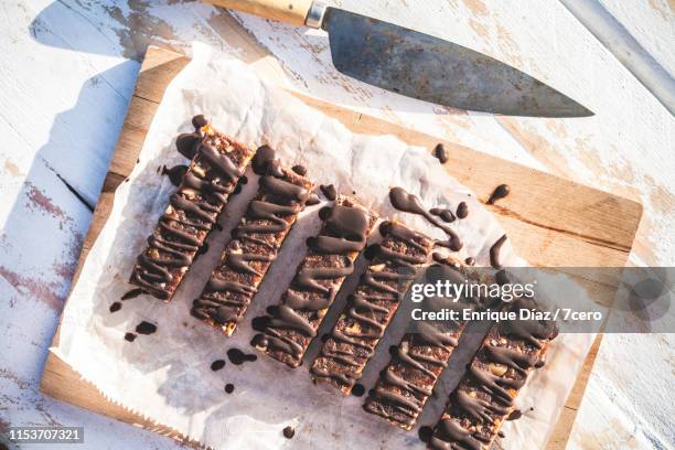 chocolate walnut energy bars with chocolate drizzle - chocolate drizzle stock pictures, royalty-free photos & images