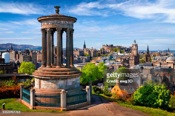 dugald stewart monument and view over historic edinburgh from calton hill, scotland, uk - edinburgh scotland stock pictures, royalty-free photos & images