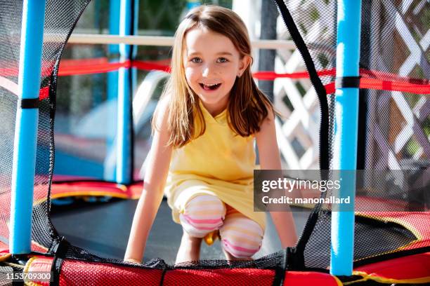 little girl jumping in a trampoline - gym equipment red stock pictures, royalty-free photos & images