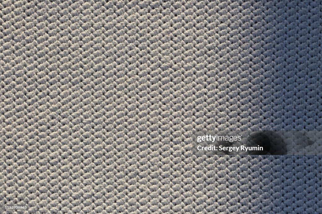 Close-up of cotton crochet knitting with a shadow