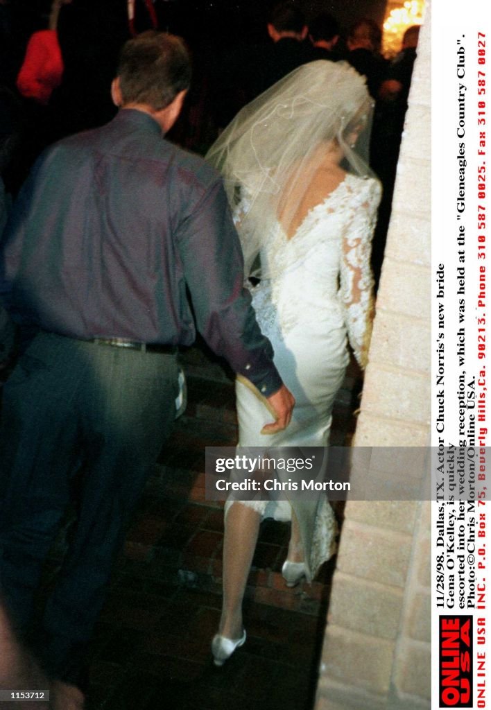 11/28/98. Dallas,TX. Actor Chuck Norris's new bride Gena O''Kelley, is quickly escorted into her wed