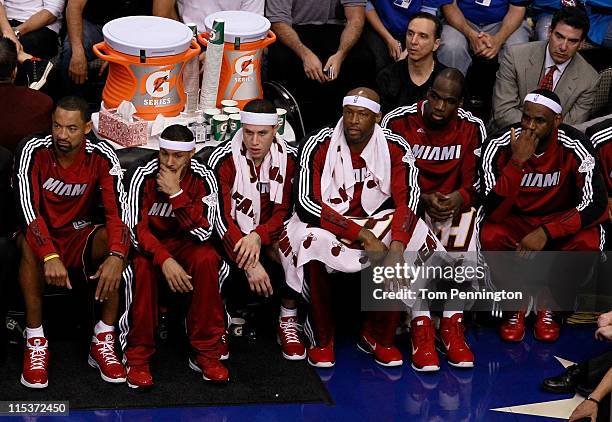 Juwan Howard, Eddie House, Mike Bibby, Erick Dampier, Joel Anthony and LeBron James of the Miami Heat sit on the bench while taking on the Dallas...