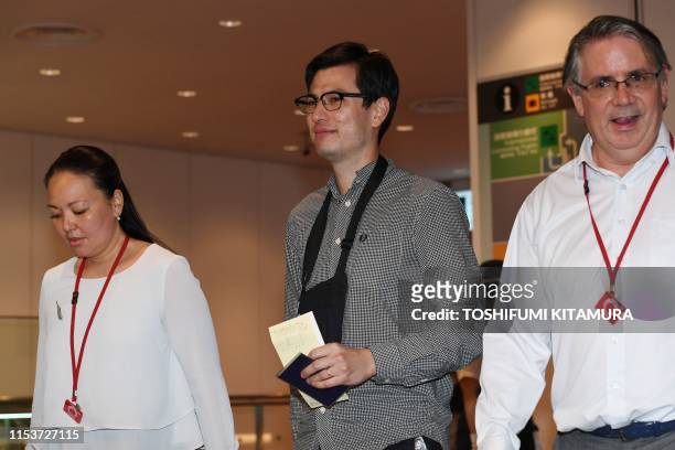 Australian student Alek Sigley looks on upon arriving at Haneda International airport in Tokyo on July 4 following his release. - A 29-year-old...